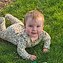 baby, child, crawling, cute, face, floral_pattern, grass, greenery, hands, happy, head, infant, nature, onesie, outdoor, person, playful, smiling, sunlight, young_child