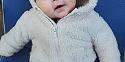 Jolie joined the competition — help win amazing prizes! baby, child, hoodie, white, furry, blue_chair, pants, patterned, cute, smiling, eyes, face, seated, warm_clothing, infant, portrait, indoor, soft_texture, apparel, young