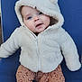 baby, child, hoodie, white, furry, blue_chair, pants, patterned, cute, smiling, eyes, face, seated, warm_clothing, infant, portrait, indoor, soft_texture, apparel, young