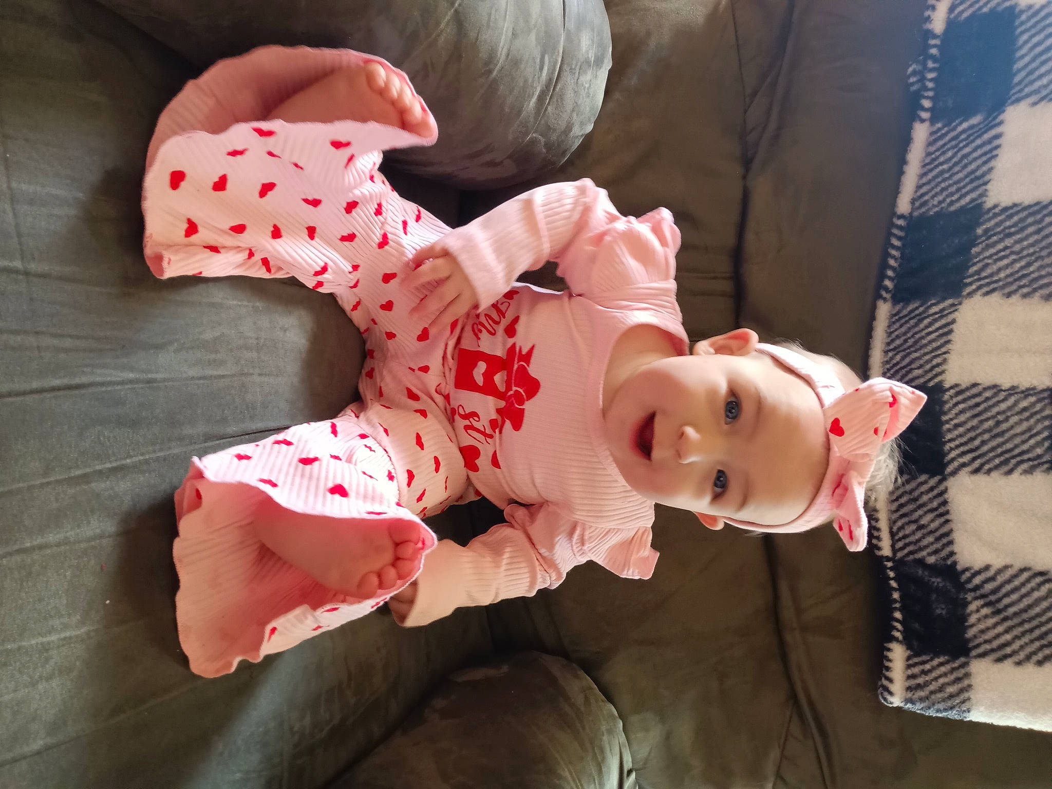 Violet is registered to the contest to win money with this photo: baby_toddler_clothing, carmine, child, comfort, costume, flesh, headwear, human_leg, joy, pattern, peach, person, pink, plush, room, sitting, sleeve, smile, stuffed_toy, thigh