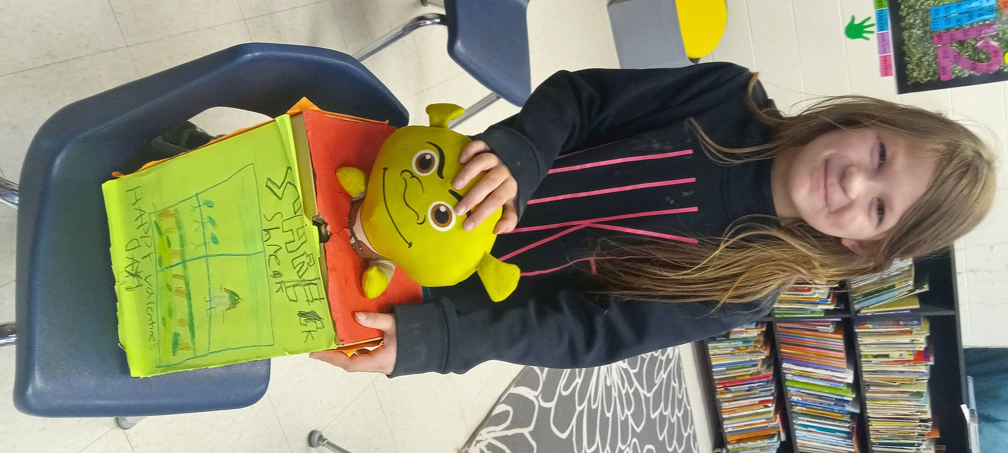 Kenleigh is registered to the contest to win money with this photo: animation, audio_equipment, child, emoticon, eyewear, fun, handwriting, happy, joy, musical_instrument, person, room, smiley, t_shirt, toy, visual_arts, writing