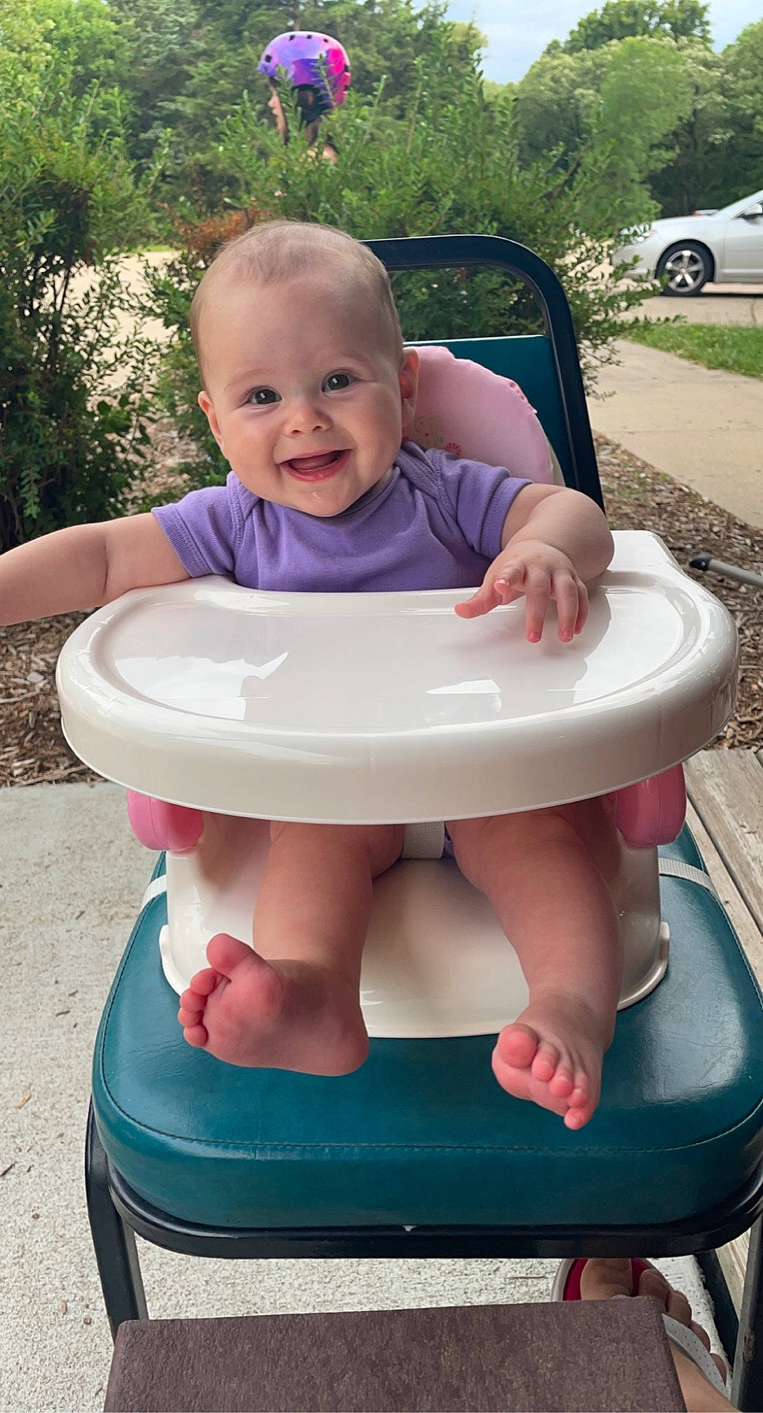 Sophia is registered to the contest to win money with this photo: arm, baby_toddler_clothing, blue, face, facial_expression, finger, hand, head, human_body, joy, mouth, muscle, organ, person, photograph, pink, plant, product, skin, smile
