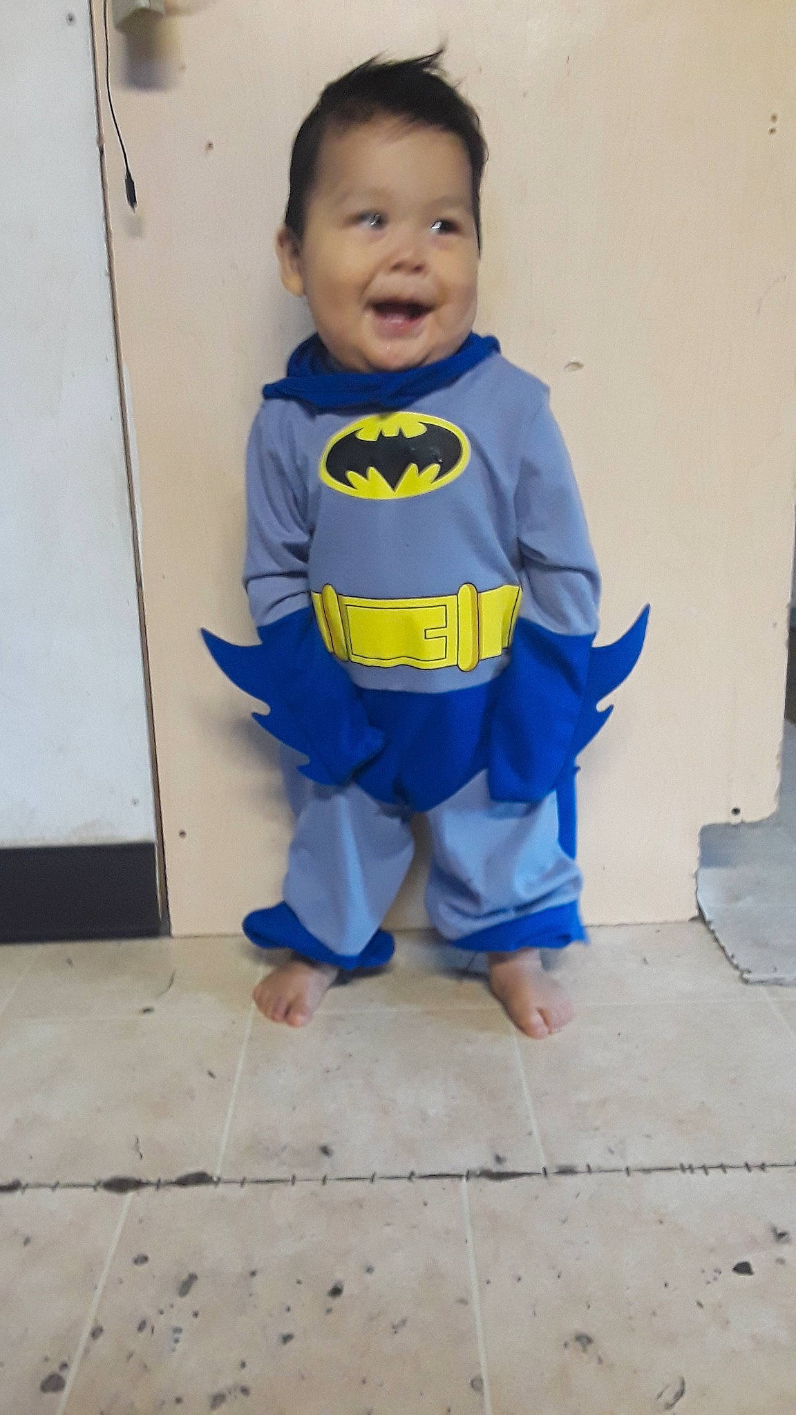 Edison is registered to the contest to win money with this photo: batman, child, clothing, costume, fictional_character, justice_league, outerwear, person, play, sleeve, smile, superhero, superman, t_shirt, toddler, yellow