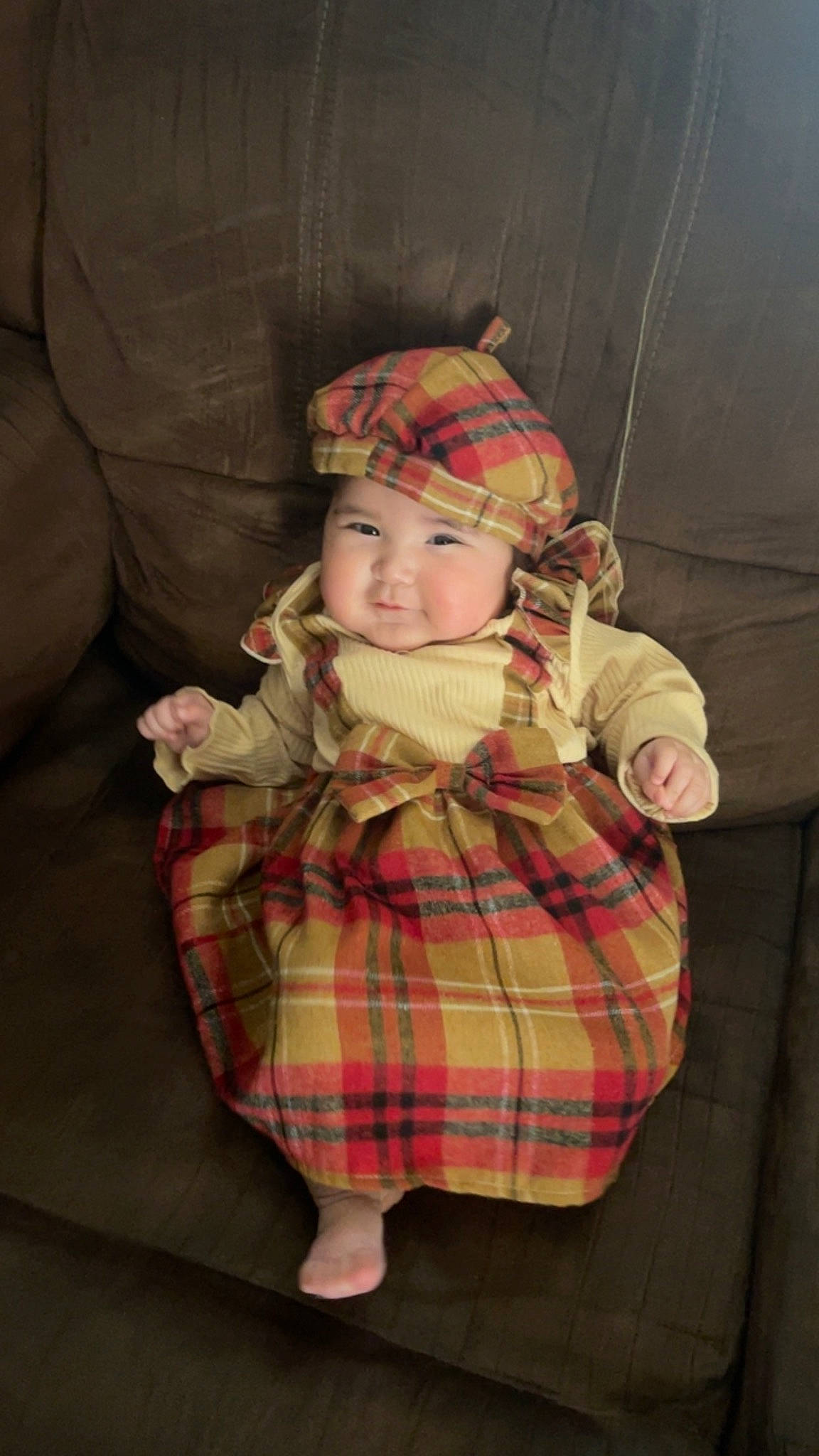 Isabella is registered to the contest to win money with this photo: baby, baby_toddler_clothing, christmas, christmas_eve, comfort, eye, fur, headwear, holiday, human_body, lap, pattern, person, plaid, room, sitting, sleeve, sock, tartan, toddler