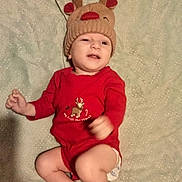 élohan a rejoint le concours — aidez-le/la à gagner de superbes lots ! baby, blanket, child, christmas, cute, diaper, festive, happy, holiday, indoors, infant, infant_clothing, lying_down, person, red_onesie, reindeer_hat, smiling, sparkly, winking, winter_hat