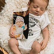 Maverick is registered to the contest to win money with this photo: baby, infant, sleeping, onesie, blanket, basket, photo, wood_floor, hand, foot, face, newborn, cozy, cute, child, person, indoor, soft_texture, clothing, peaceful