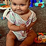 baby, carpet, child, childhood, cute, expression, face, floor, foot, furniture, hand, home, indoor, infant, onesie, play, room, sitting, smile, toy
