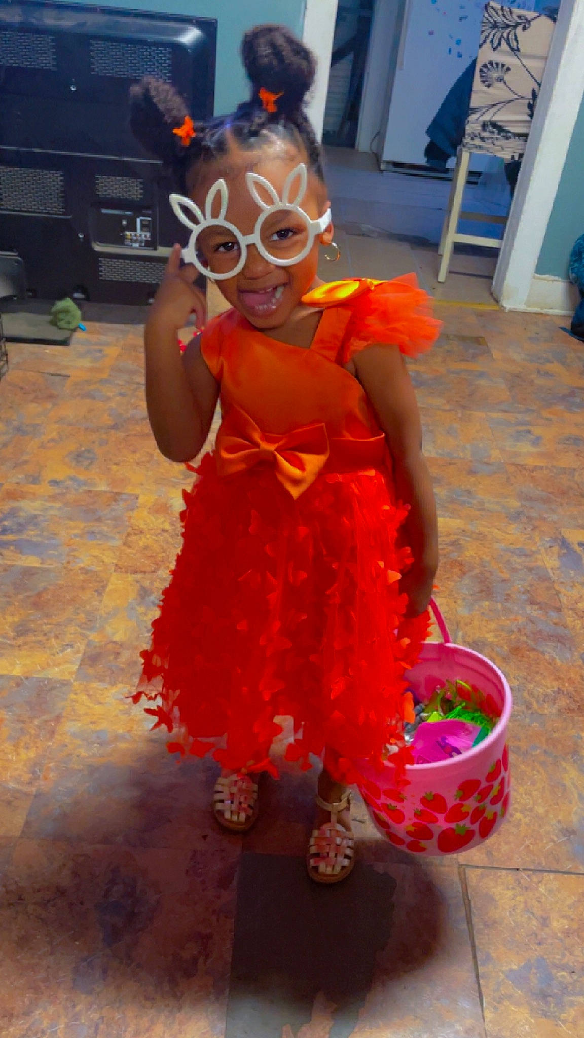 Majesty is registered to the contest to win money with this photo: boot, chair, child, costume, entertainment, event, eyewear, fictional_character, flooring, fun, fur, glove, happy, human_leg, joy, orange, party_supply, performing_arts, person, personal_protective_equipment