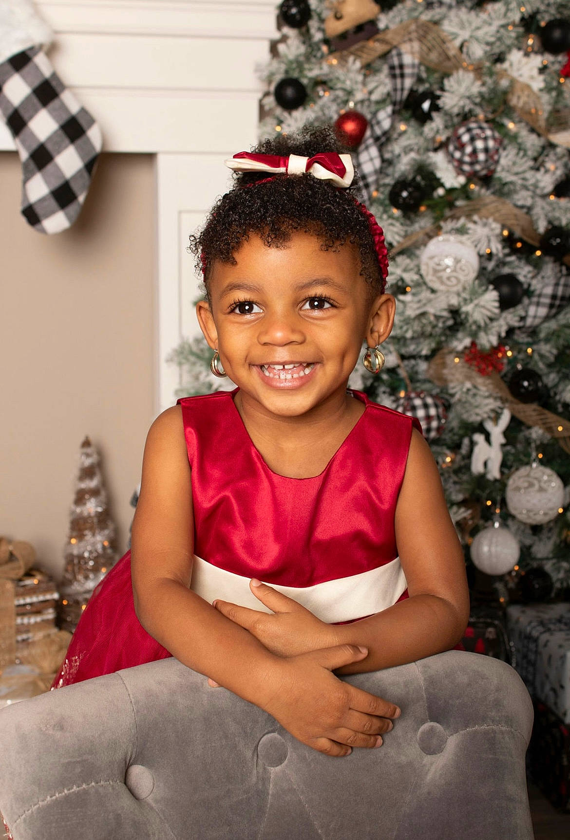 Majesty is registered to the contest to win money with this photo: child, chin, christmas_decoration, dress, event, eye, facial_expression, flash_photography, fun, hair, happy, human_leg, joy, magenta, ornament, person, sitting, smile, standing, temple