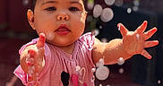 Emily is registered to the contest to win money with this photo: baby, child, closeup, cute, droplets, expression, face, fun, hands, happy, hearts, outdoor, pink_shirt, playful, sitting, skin, summer, sunlight, water, wet_hair