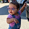 accessory, car, casual_clothing, child, cute, denim, fashion, hair_tie, outdoor, overalls, person, pink, playful, shoes, small_child, standing, summer, sunglasses, sunlight, toddler
