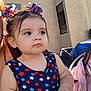 baby, baseball, blanket, blue_dress, building, child, cute, daylight, expression, face, hair_bows, outdoor, person, portrait, sign, star_pattern, stroller, toddler, toy, window