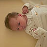 Clara is registered to the contest to win money with this photo: newborn, baby, infant, blanket, swaddle, cute, sleepwear, animal_print, soft, cozy, lying_down, pale_yellow, curious, tiny_fists, face, head, skin, hair, indoors, portrait