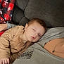 Kaleb is registered to the contest to win money with this photo: baby, sleeping, couch, blanket, adult, cozy, indoor, child, relaxation, comfort, face, person, clothing, home, rest, nap, peaceful, soft, warm, casual