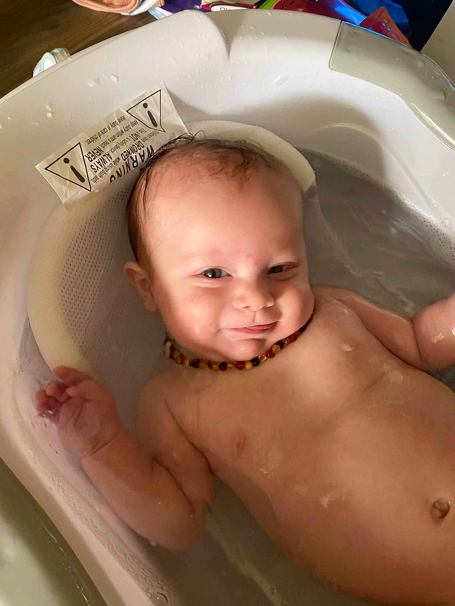 Kylan is registered to the contest to win money with this photo: baby_bathing, bathing, cheek, chin, eyebrow, facial_expression, fluid, forehead, hairstyle, iris, jaw, lip, mouth, neck, nose, person, product, skin, smile, stomach