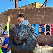 Gabriel joined the competition — help win amazing prizes! accessories, animal, art, bag, boy, bull, child, clothing, face, handbag, hat, head, lion, male, pants, person, photography, portrait, shorts, t_shirt