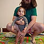Otis joined the competition — help win amazing prizes! adult, barefoot, beard, casual_clothing, child, colorful, crouching, family, father, floor, holding, home, indoor, parent, play_mat, portrait, smile, tattoo, toddler, toy_mat