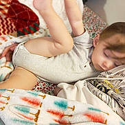 Otis joined the competition — help win amazing prizes! arm, baby, bed, bedspread, blanket, child, clothing, cozy, face, homedecor, leg, nap, onesie, patterned_blanket, person, pillow, portrait, sleeping, sleepy, toddler