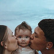 Ezra joined the competition — help win amazing prizes! baby, child, adult, kiss, affection, family, outdoor, sky, portrait, love, parent, people, face, closeup, emotion, togetherness, clothing, head, skin, person