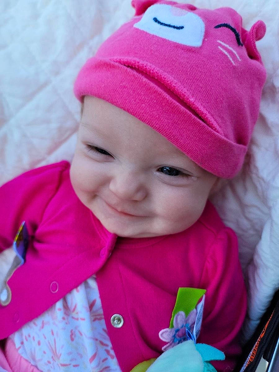 Madelyn is registered to the contest to win money with this photo: baby_toddler_clothing, blue, cap, cheek, child, clothing, happy, headgear, headwear, knit_cap, lip, magenta, outerwear, person, pink, product, purple, skin, sleeve, smile