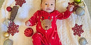 Samuel is registered to the contest to win money with this photo: baby, infant, red_onesie, reindeer, christmas_ornaments, pine_cones, blanket, holiday, festive, decorations, cute, portrait, indoors, smiling, holiday_season, christmas, child, face, cozy, soft