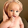 Ambre participe au concours pour gagner de l'argent avec cette photo : baby, infant, child, face, hand, finger, skin, blue_eyes, headwear, knit_hat, portrait, cute, soft_lighting, indoors, expression, looking_at_camera, cheeks, naked_torso, fingers_in_mouth, closeup