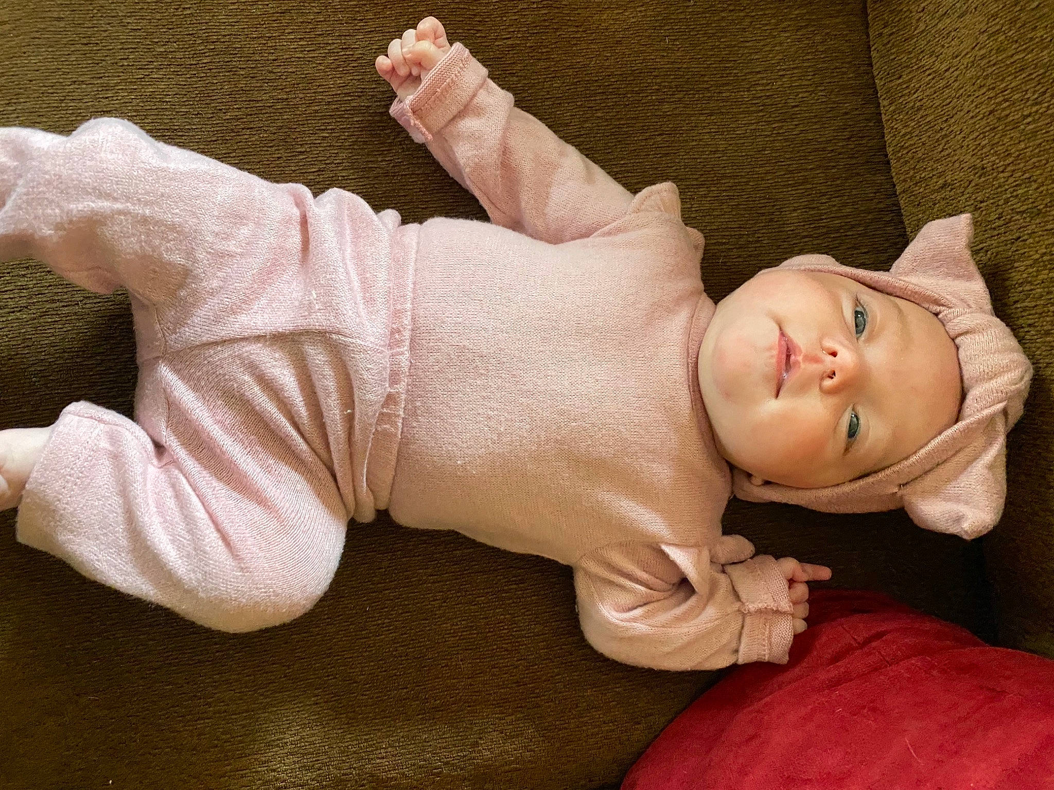 Fallon is registered to the contest to win money with this photo: arm, baby, baby_toddler_clothing, cheek, chin, ear, eyebrow, fawn, finger, gesture, glasses, hand, headwear, human_body, joint, lip, neck, person, pink, skin