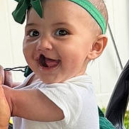 Brendalee is registered to the contest to win money with this photo: baby, child, smiling, headband, green_bow, white_shirt, face, happy, portrait, cute, infant, cheerful, young_child, closeup, skin, eyes, ears, indoor, person, toddler