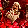 baby, child, smiling, santa_hat, christmas, holiday_lights, red_chair, wrapped_gifts, festive_clothing, indoors, celebration, joyful, cute, toddler, holiday_decor, seasonal, red, white, happy, portrait