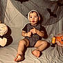 baby, bat_decoration, candle, child, cloth_backdrop, costume, curious, cute, decoration, expression, face_paint, foot, halloween, hand, holiday, indoors, portrait, pumpkin, sitting, toddler