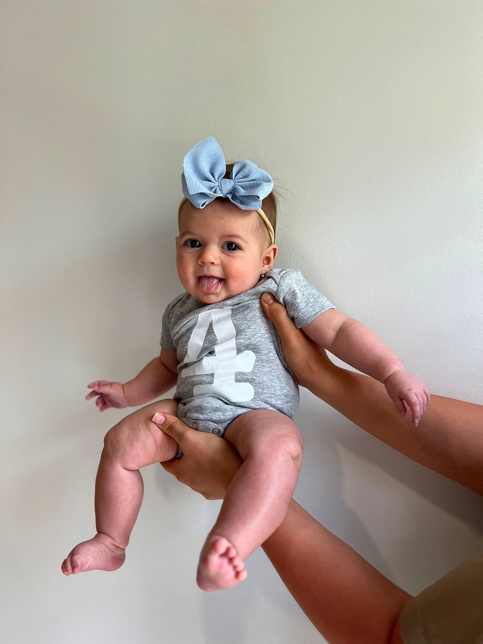 Aislynn is registered to the contest to win money with this photo: baby, baby_toddler_clothing, child, comfort, fashion_accessory, flash_photography, foot, happy, headband, headwear, human_leg, knee, pattern, person, pink, sitting, skin, sleeve, smile, thigh
