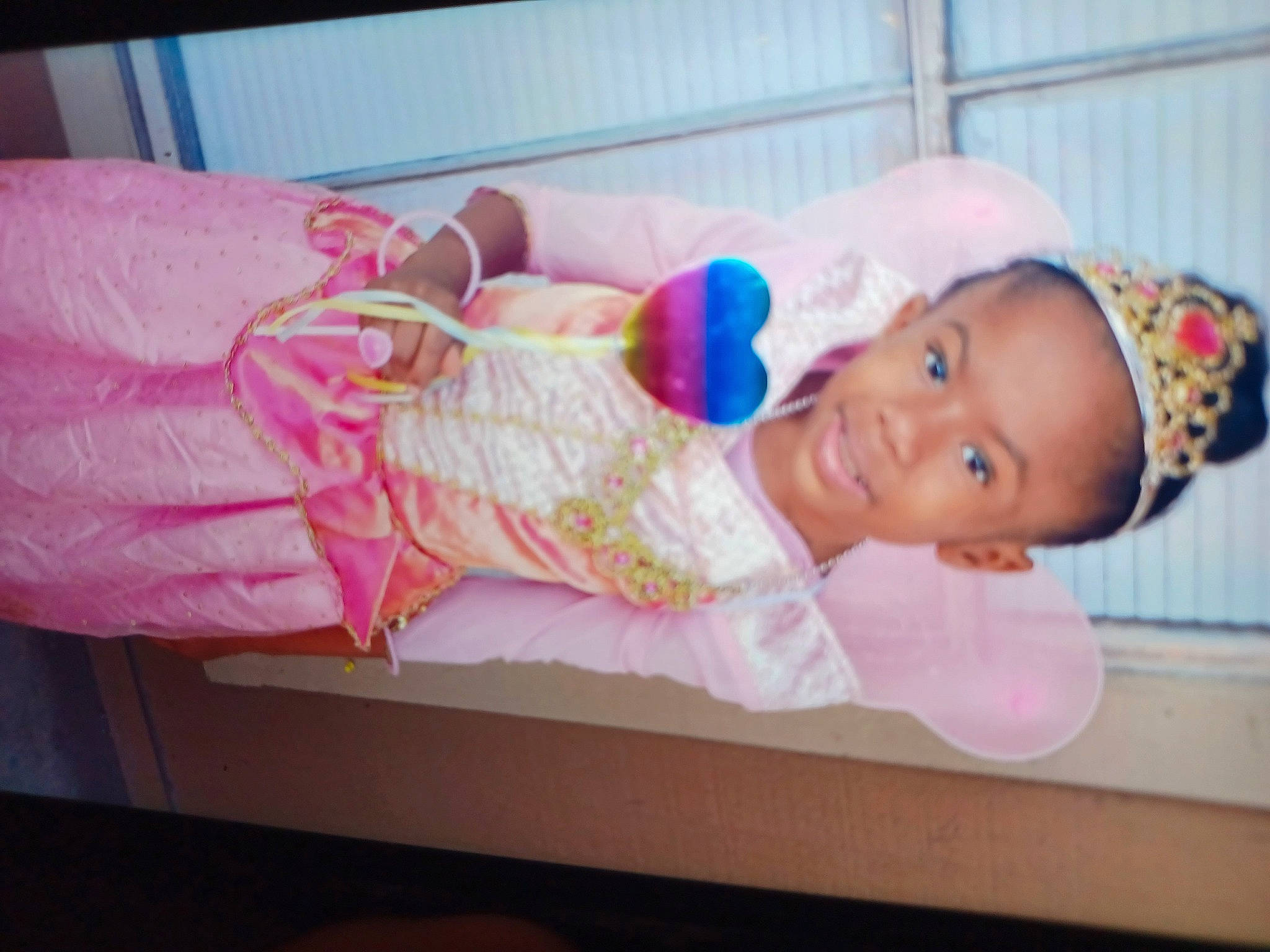 Meela is registered to the contest to win money with this photo: baby, baby_products, baby_safety, baby_toddler_clothing, child, event, happy, hat, human_body, joy, magenta, person, pink, room, skin, smile, toddler