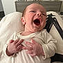 baby, newborn, infant, smiling, mouth_open, hands, onesie, lap, closeup, portrait, cheerful, indoor, blanket, furniture, dresser, photography, skin, head, happy, tiny_fingers