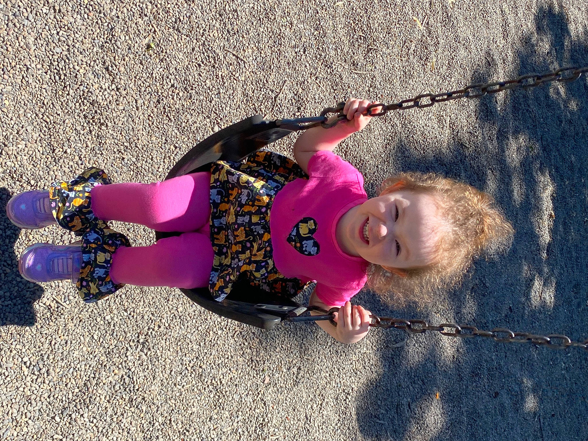 Amber is registered to the contest to win money with this photo: asphalt, child, electric_blue, fun, grass, happy, joy, leisure, magenta, people_in_nature, person, play, purple, recreation, shadow, sidewalk, smile, toddler, tree, water