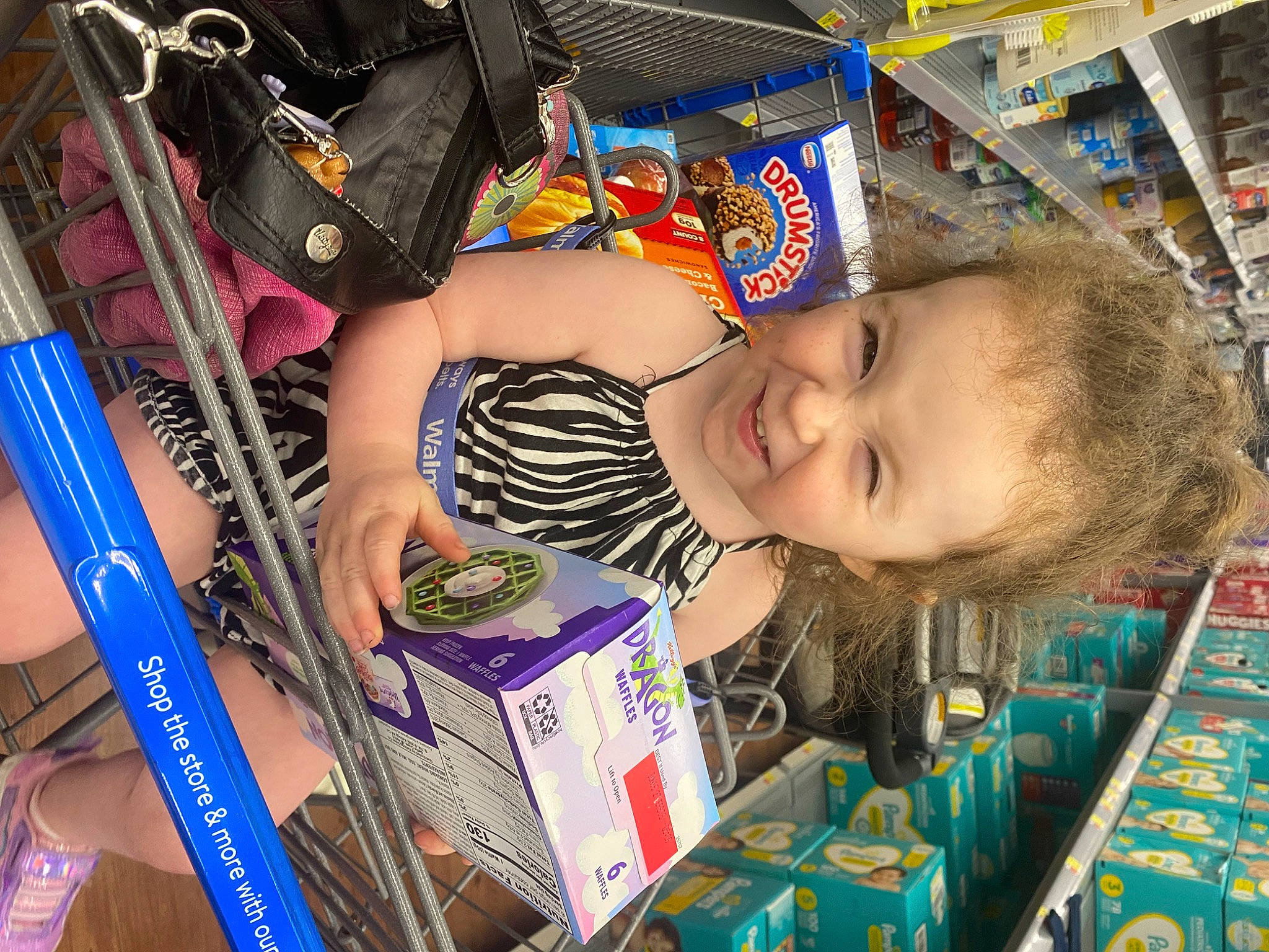 Amber is registered to the contest to win money with this photo: baby, baby_products, baby_toddler_clothing, cheek, child, customer, fun, happy, iris, person, product, publication, retail, shelf, smile, t_shirt, toddler, toy