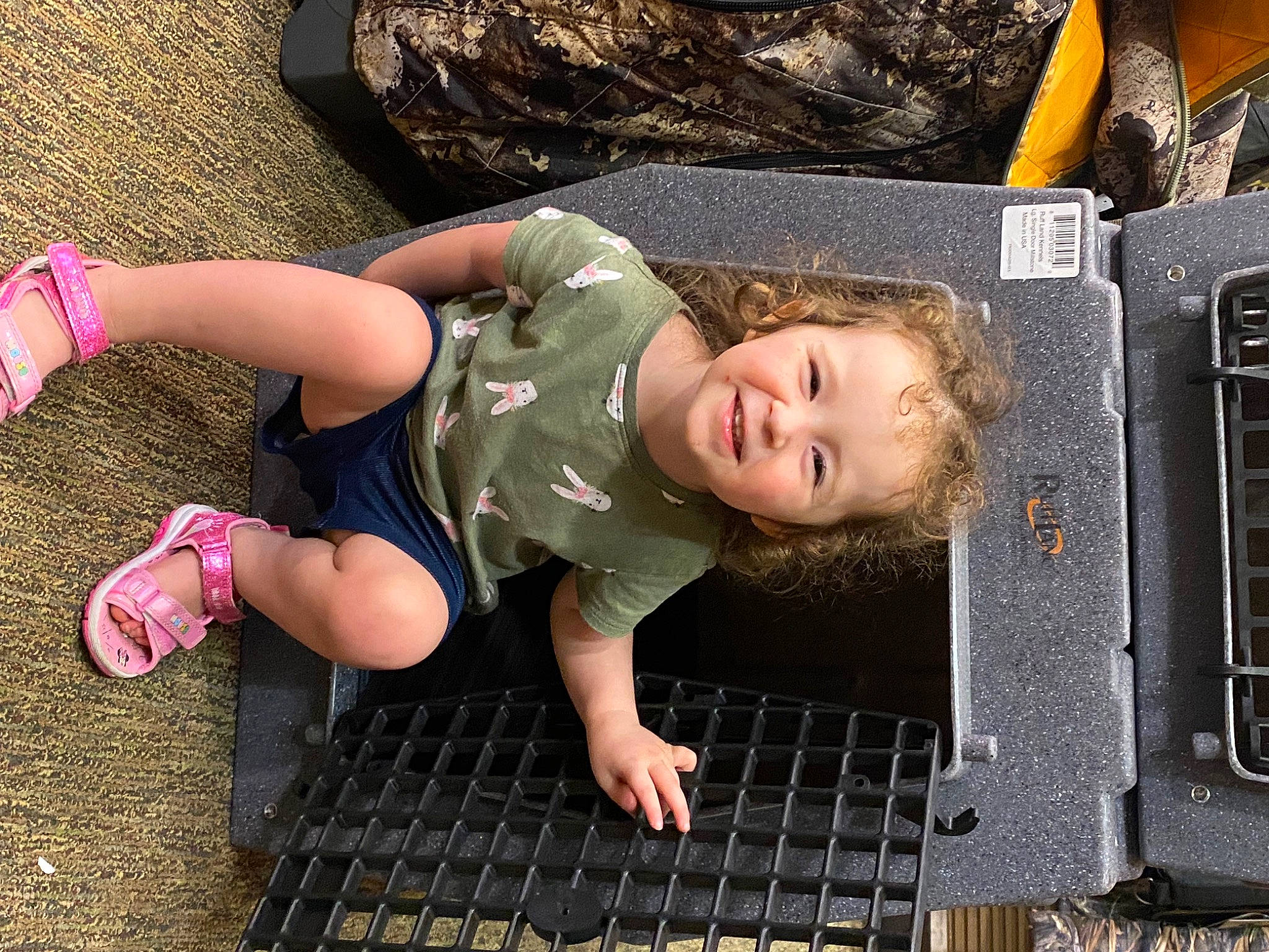 Amber is registered to the contest to win money with this photo: barefoot, bumper, child, foot, fun, grass, human_leg, leisure, motor_vehicle, people_in_nature, person, play, sandal, sitting, smile, soil, thigh, toddler, vacation, wood