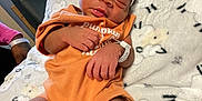 Amiria joined the competition — help win amazing prizes! newborn, baby, infant, sleeping, orange_outfit, headband, bow, blanket, sheep_pattern, hospital, hospital_id_band, cozy, cute, resting, person, indoors, soft_texture, closeup, peaceful, child