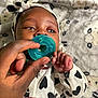 Amiria joined the competition — help win amazing prizes! baby, infant, pacifier, hand, blanket, headband, black_and_white, heart_pattern, close_up, cute, clothing, sleepwear, soft_texture, human, child, newborn, portrait, resting, indoors, comfort