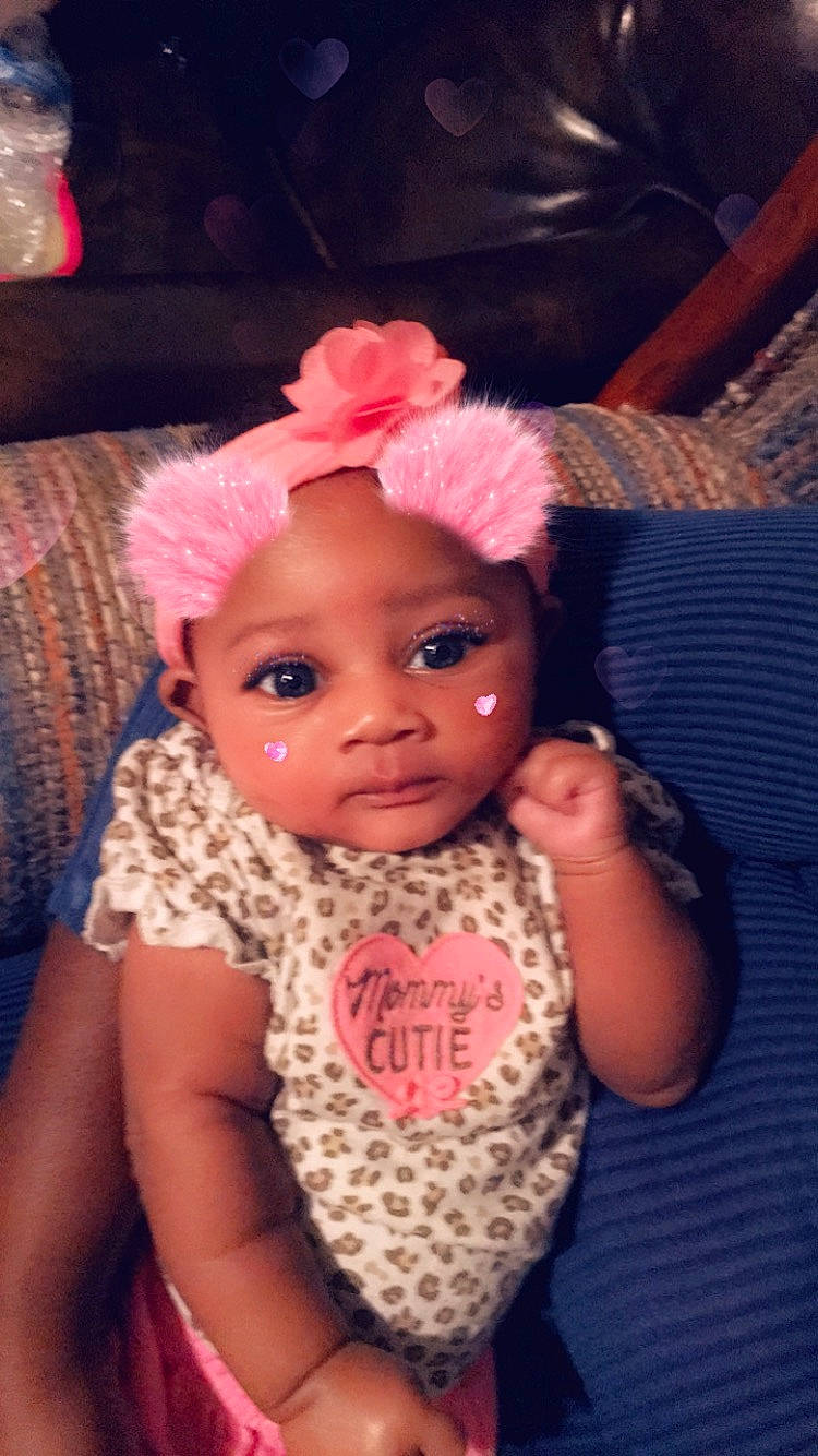 Marie is registered to the contest to win money with this photo: art, baby, cheek, child, crochet, face, hair_accessory, head, headband, headgear, knitting, lip, nose, person, pink, skin, toddler, wool