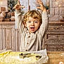 baking, blond_hair, celebration, child, cookie_cutter, cute, festive, flour, food_preparation, holiday_decor, indoors, joyful, kitchen, rolling_pin, smiling, sweater, table, toddler, window, winter