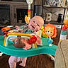 baby, child, colorful, cushion, decor, fisher_price, foot, furniture, happy, infant, jumper, living_room, nickelodeon, person, plant, shelf, smiling, television, toy, wood_floor