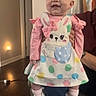 Leilani is registered to the contest to win money with this photo: baby, bunny, child, colorful, cute, dress, floor, footwear, happy, headband, holding, indoor, light, pattern, person, pink, polka_dot, smiling, toddler, white_shoes