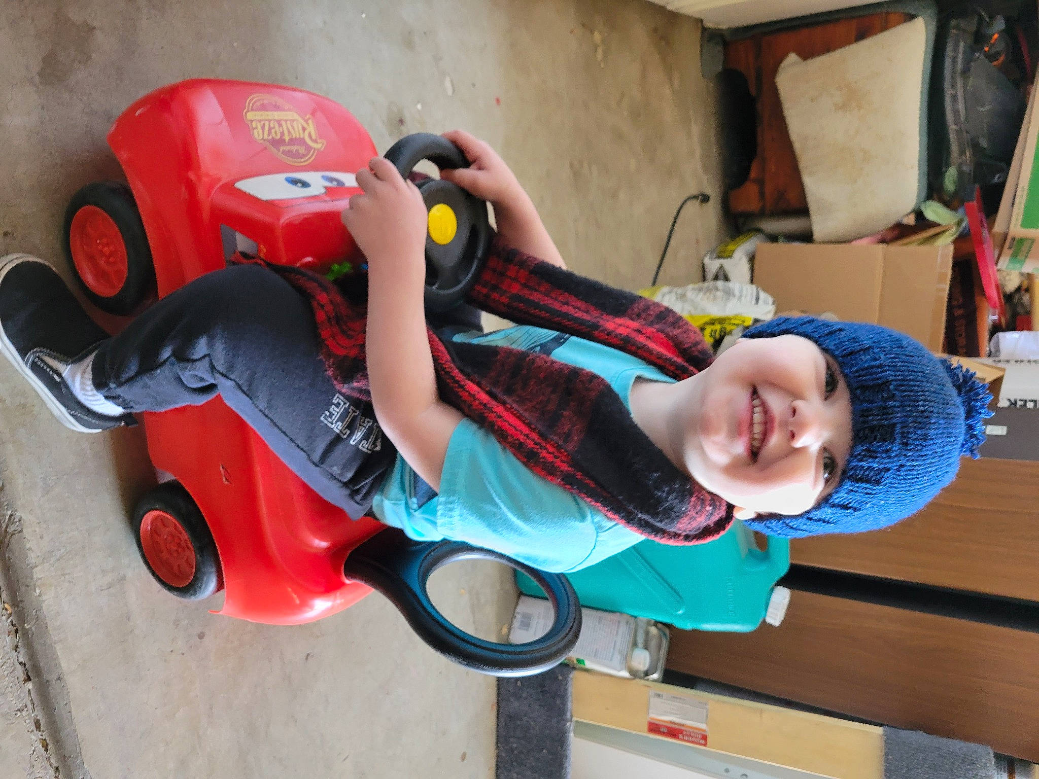 Kasen is registered to the contest to win money with this photo: automotive_design, car, carmine, chair, child, fender, fictional_character, fun, hat, headwear, helmet, joy, leisure, person, personal_protective_equipment, plastic, play, smile, tire, toddler