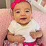 baby, smiling, headband, pink, skirt, polka_dot, white, cushion, sitting, cute, infant, happy, clothing, bracelet, portrait, indoors, soft, child, person, toddler