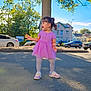 toddler, child, purple_dress, white_tights, sneakers, outdoor, tree, street, cars, daylight, side_view, sunny, gesture, playful, young_girl, urban, residential_area, happy, person, summer
