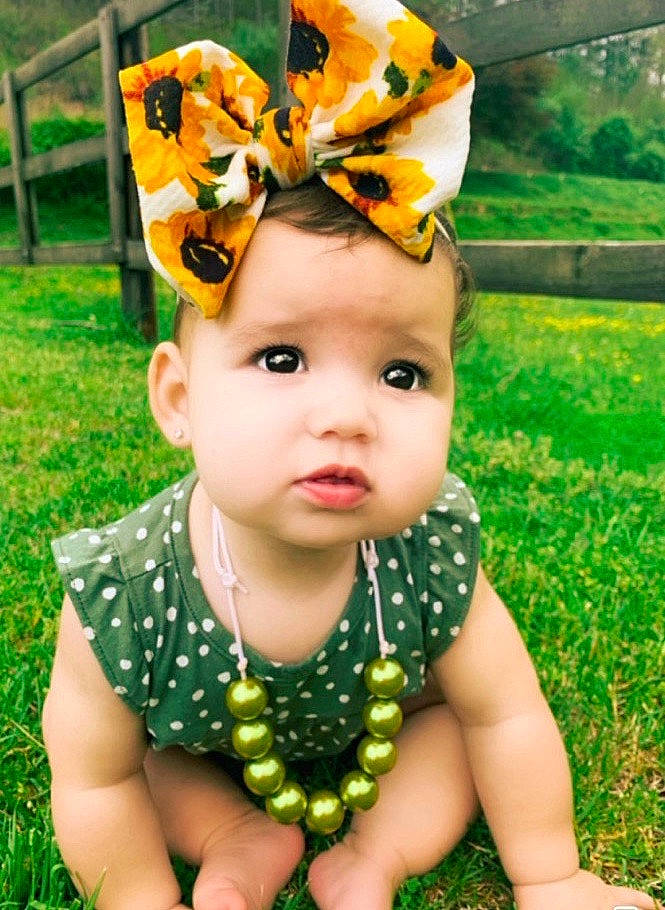 Hadlee joined the competition — help win amazing prizes! baby, baby_bloomers, baby_products, baby_toddler_clothing, child, clothing, costume_accessory, design, fashion_accessory, fawn, grass, hair_accessory, headband, headgear, pattern, person, toddler, yellow