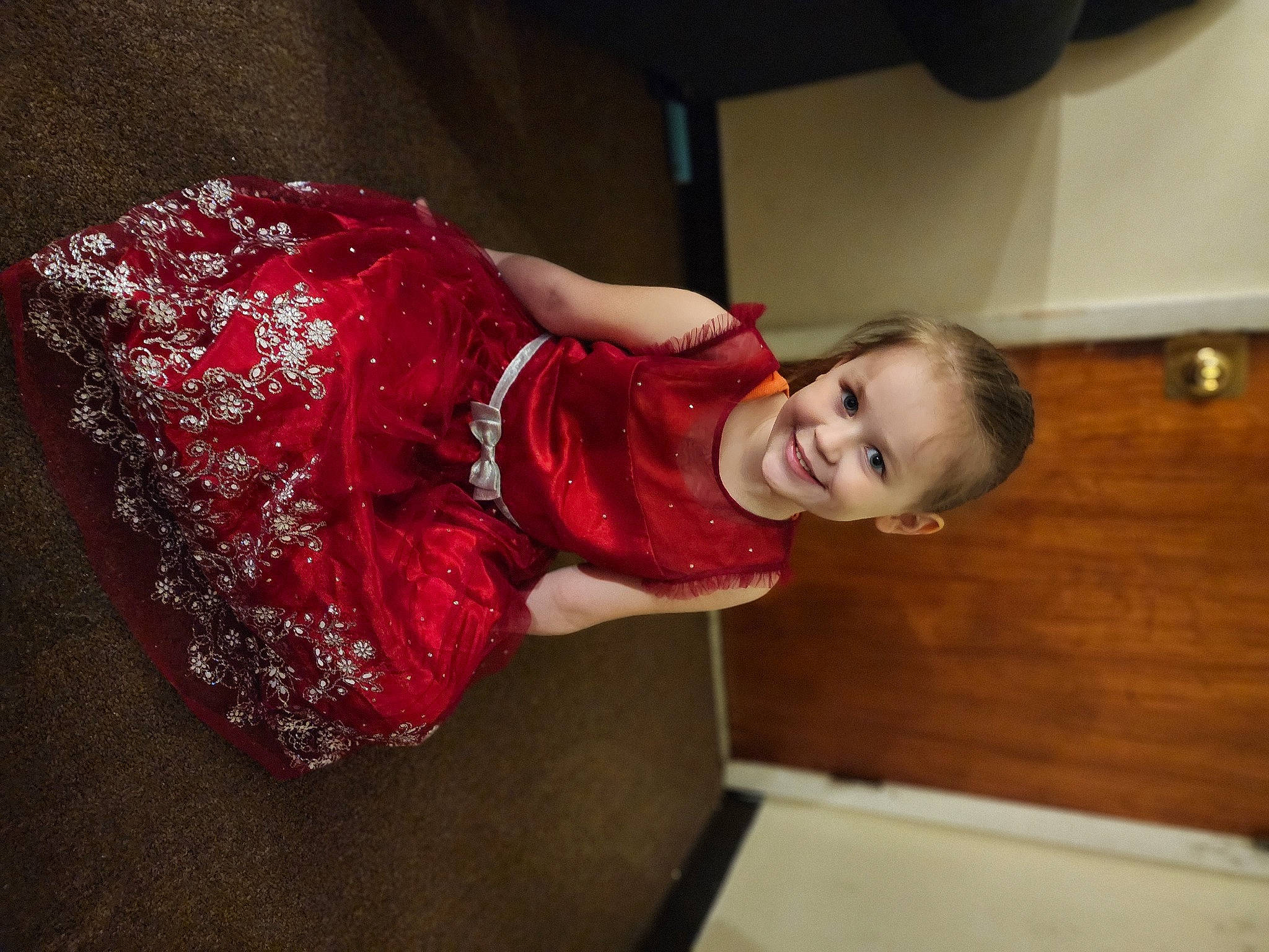 Aspen is registered to the contest to win money with this photo: baby_toddler_clothing, carmine, child, elbow, event, flooring, fun, happy, human_leg, joy, magenta, pattern, person, room, sitting, sleeve, smile, toddler, wood