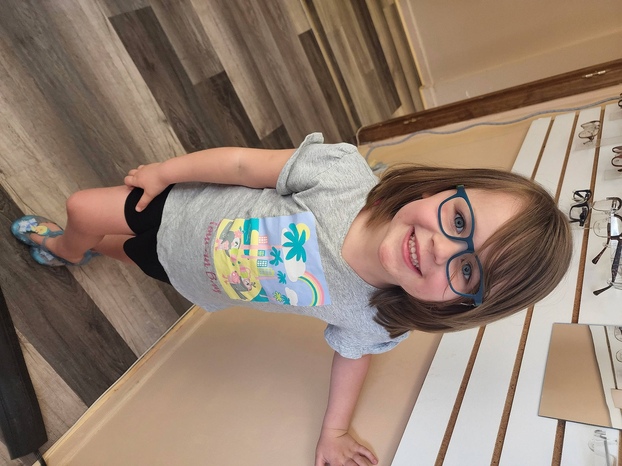 Aspen is registered to the contest to win money with this photo: baby_toddler_clothing, child, cool, eyewear, fun, glasses, happy, human_leg, joint, joy, knee, leisure, pattern, person, sandal, skin, smile, thigh, toddler, vision_care