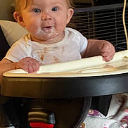 Azmae joined the competition — help win amazing prizes! baby, child, high_chair, infant, smiling, portrait, sitting, indoors, face, eyes, hair, hands, bib, feeding, milk, tray, furniture, home, kitchen, photography