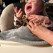 Freya is registered to the contest to win money with this photo: adult, air_conditioner, baby, blanket, butterfly, caregiver, chair, child, clothing, cushion, face, hands, happy, home, indoor, infant, joy, laughing, portrait, smiling